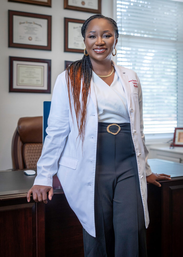 Smiling doctor standing in office
